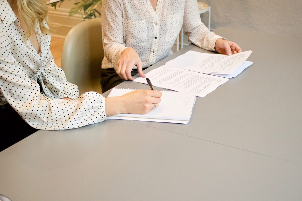 Woman signing white paper